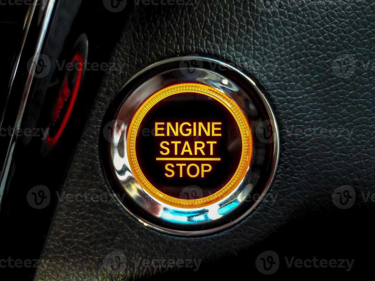 Engine Start or stop button in a conventional modern car. Car instrument panel, interior dashboard control. photo