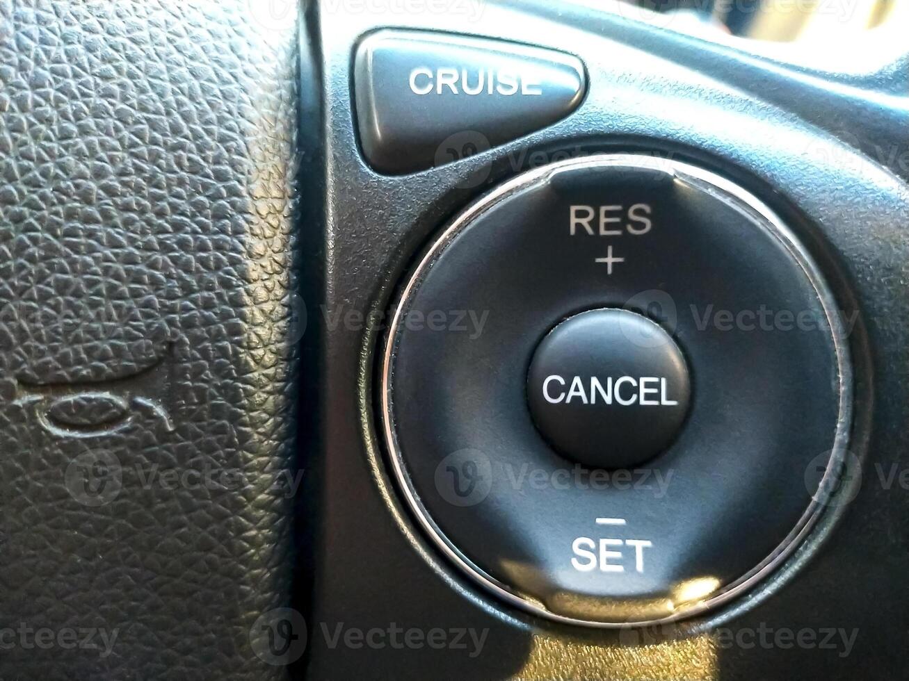 Cruise control button in conventional modern car. Car instrument panel, interior dashboard control. photo