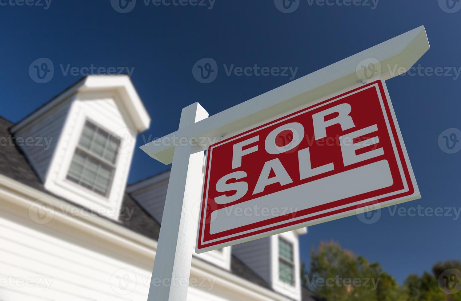 For Sale Real Estate Sign in Front of New House. photo