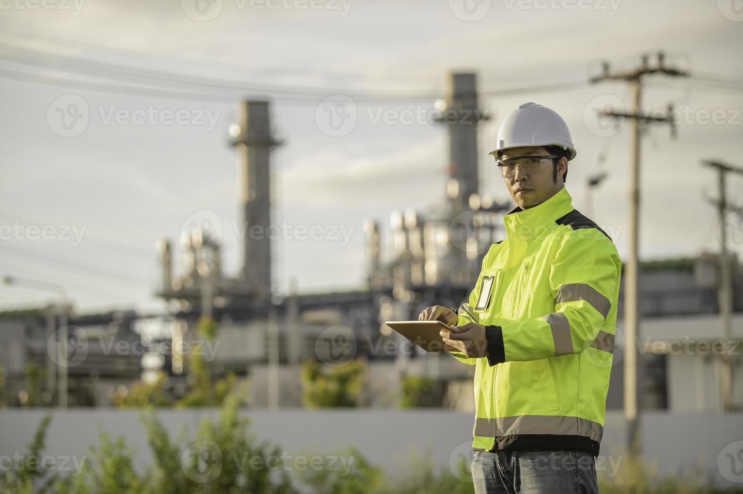 Asian man petrochemical engineer working at oil and gas refinery plant industry factory,The people worker man engineer work control at power plant energy industry manufacturing photo