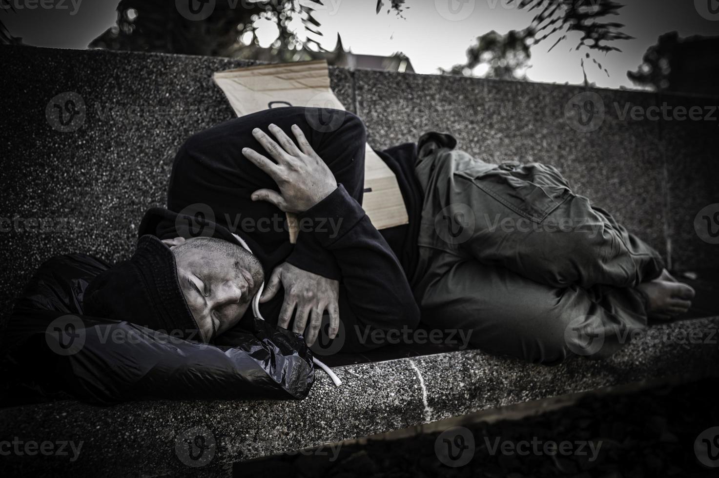 Asian man is homeless at the side road,A stranger has to live on the road alone because he has no family. photo