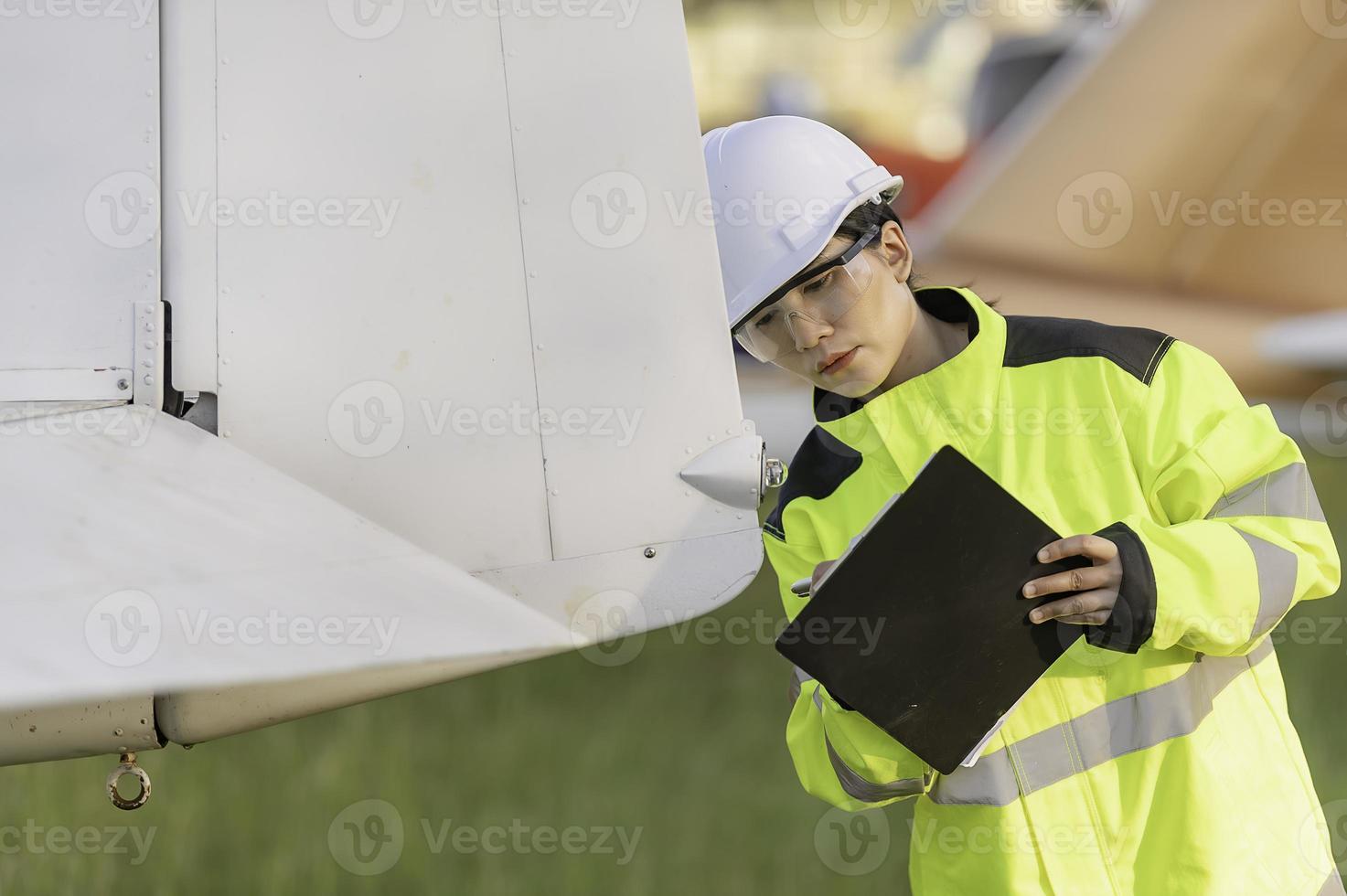 Technician fixing the engine of the airplane,Female aerospace engineering checking aircraft engines,Asian mechanic maintenance inspects plane engine photo