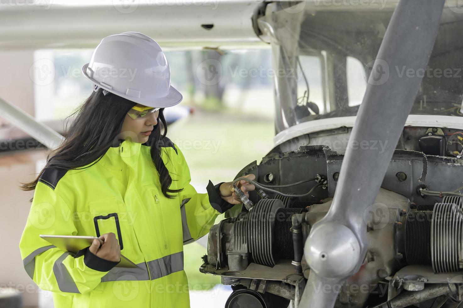 Technician fixing the engine of the airplane,Female aerospace engineering checking aircraft engines,Asian mechanic maintenance inspects plane engine photo