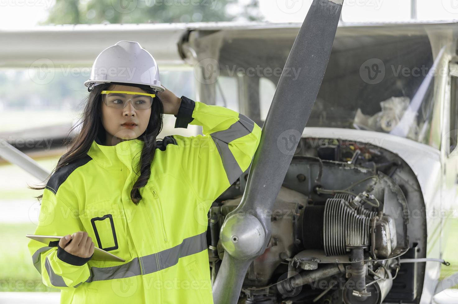 Technician fixing the engine of the airplane,Female aerospace engineering checking aircraft engines,Asian mechanic maintenance inspects plane engine photo