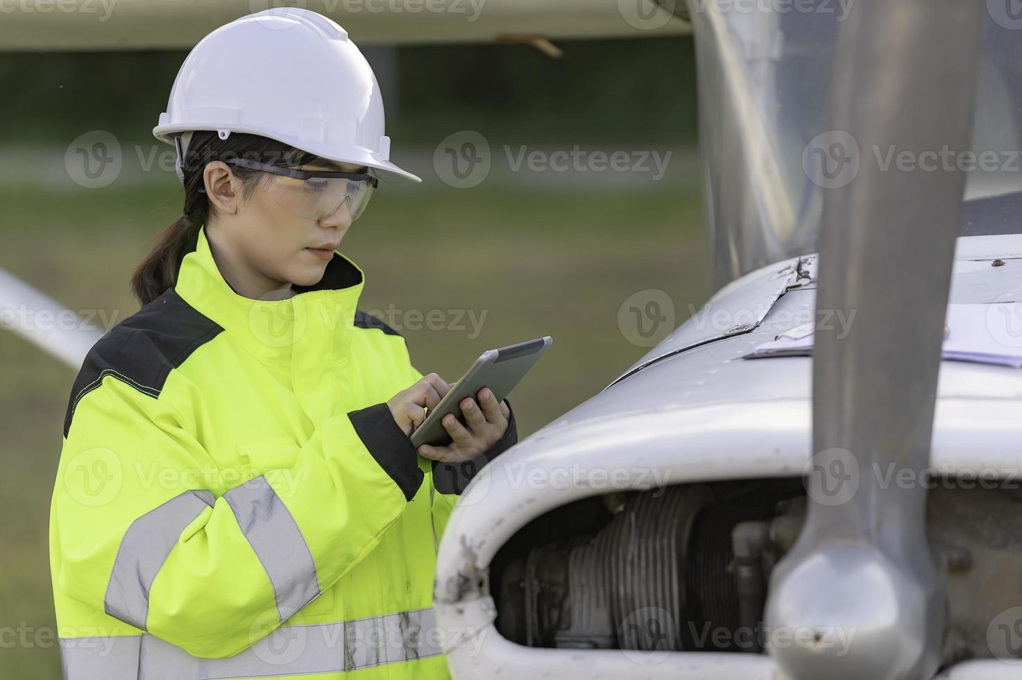 Technician fixing the engine of the airplane,Female aerospace engineering checking aircraft engines,Asian mechanic maintenance inspects plane engine photo