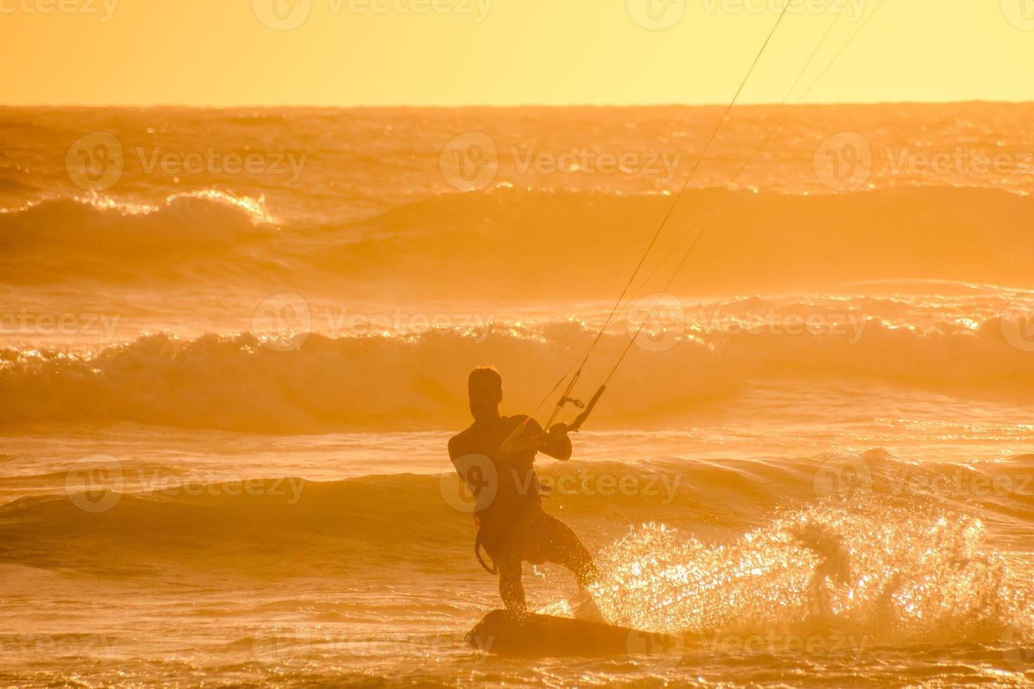 Kitesurfer at sunset photo