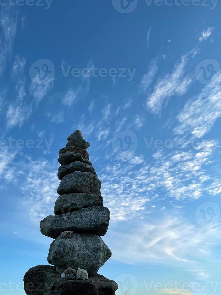 Pyramid of stones against the sky, the concept of balance. photo