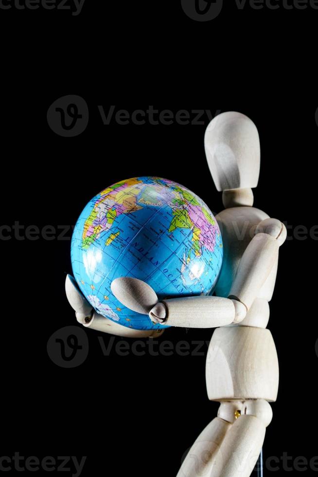 Wooden mannequin figurine on dark background photo