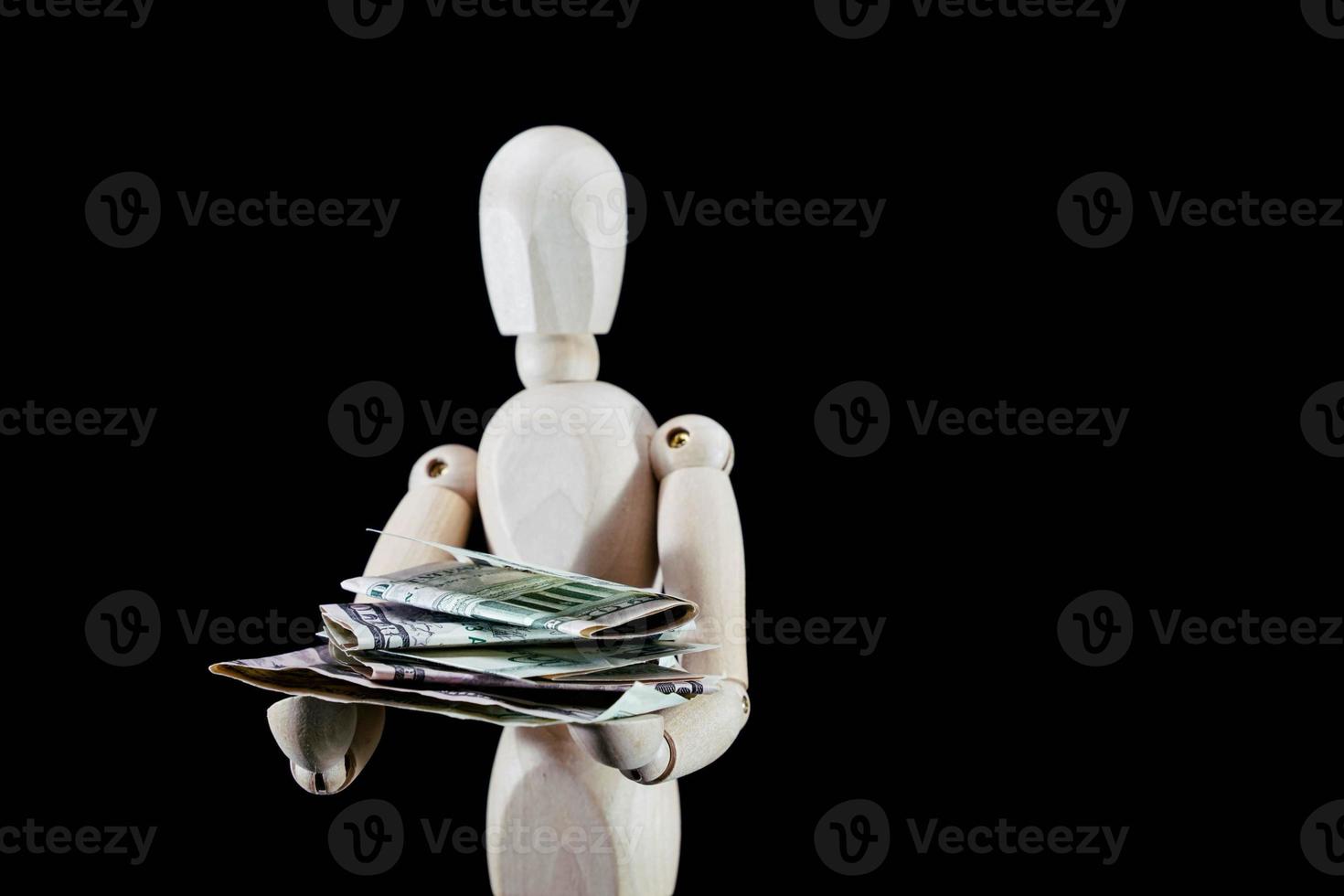 Wooden mannequin figurine on dark background photo