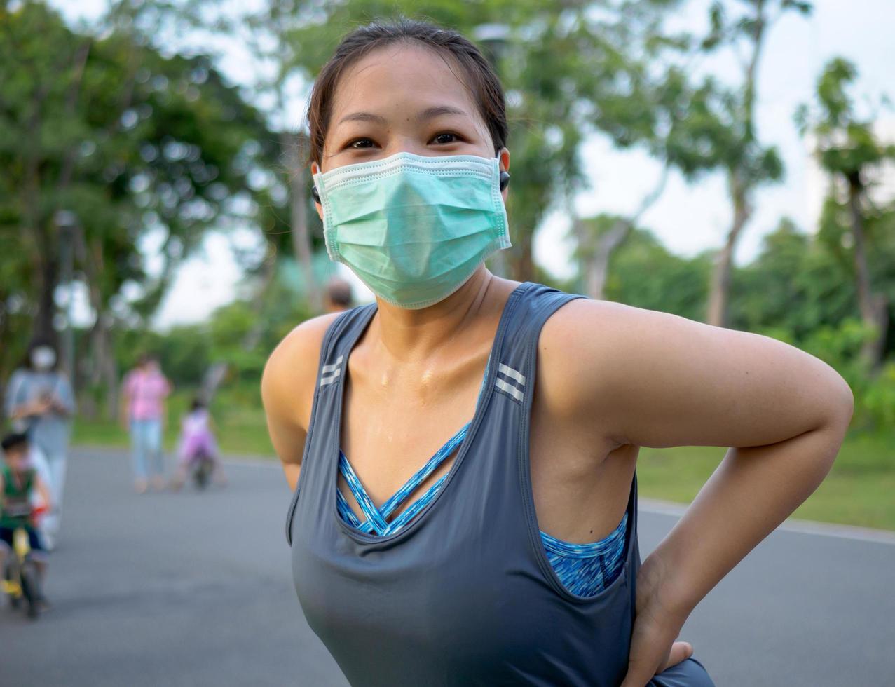 Portrait beautiful Asian woman in sportswear, standing with her back, stretching before exercising outdoor in park  morning to achieve healthy lifestyle. healthy  warming up photo