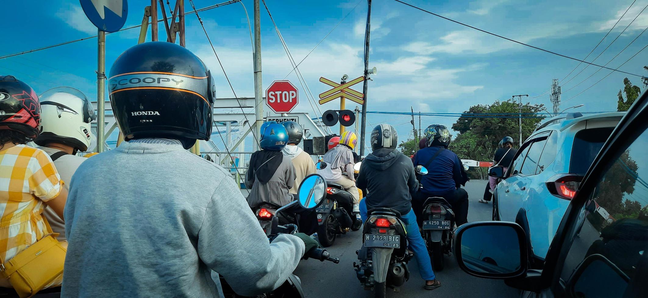 vehículos detener a el ferrocarril cruce, semarang, Indonesia marzo 2023 foto