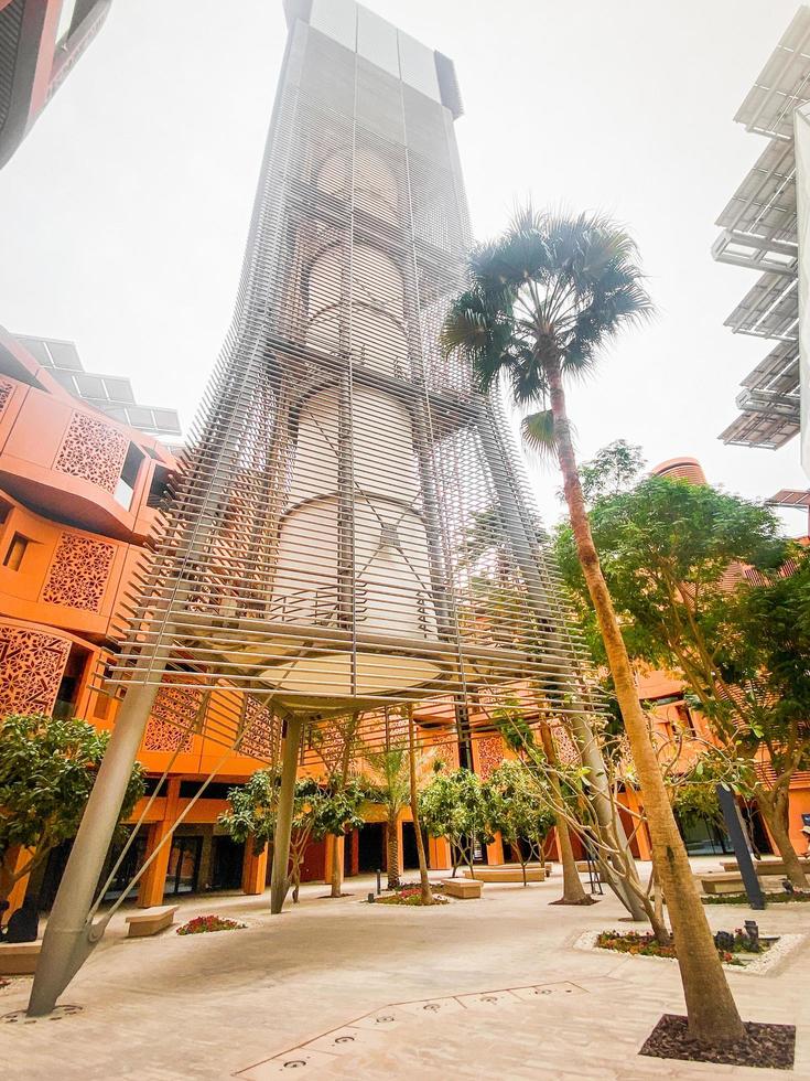 UAE, Abu Dhabi, 2023 - Wind Tower and surrounding buildings in Masdar City photo