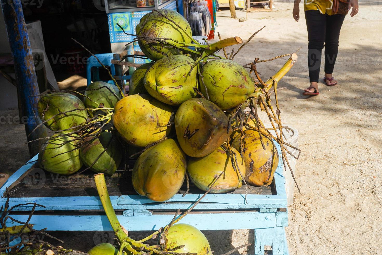 selling young coconuts kelapa muda tender coconut, Spanjang the beach, yogyakata, indonesia photo