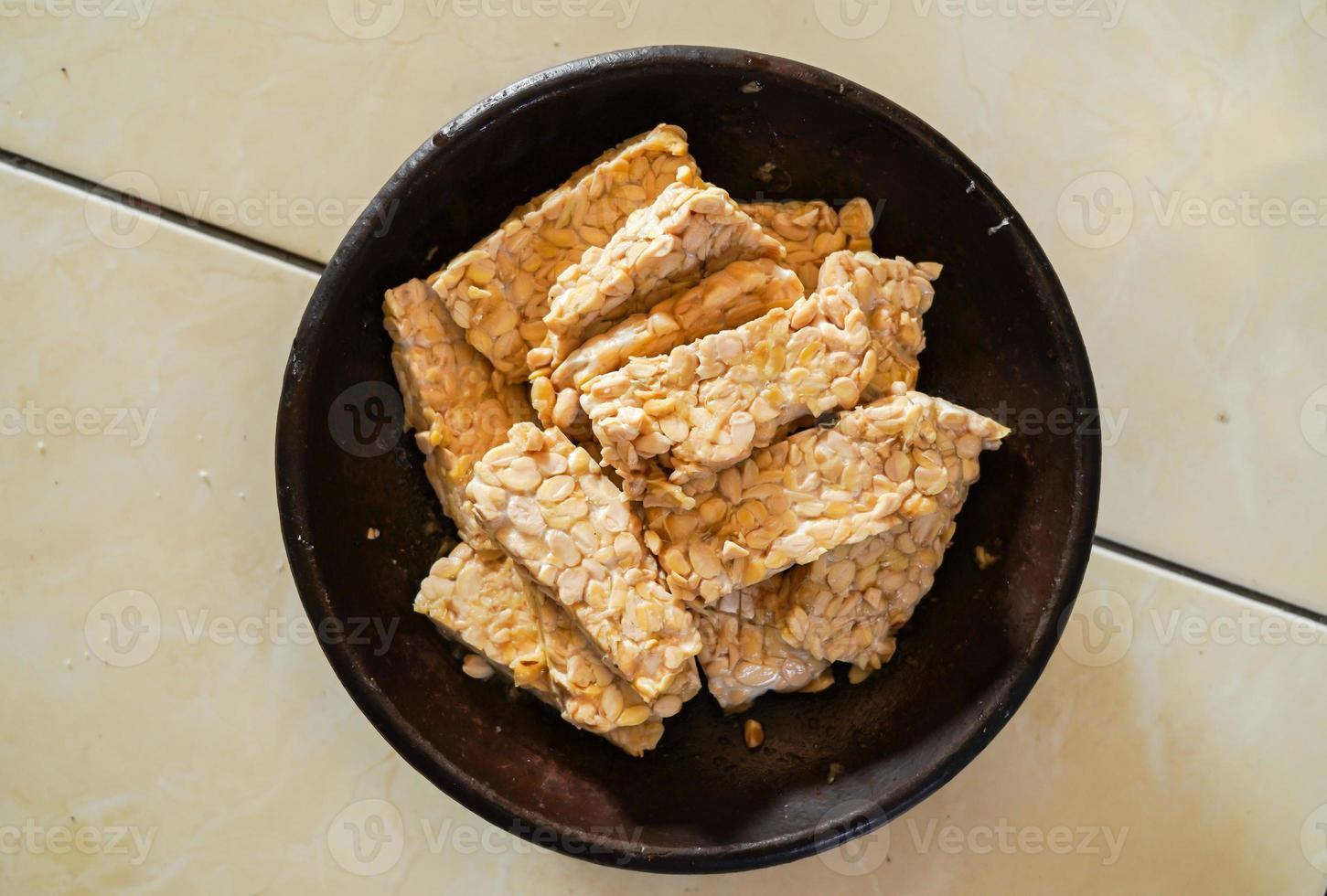 raw tempeh, ready to cook, Tempe is a traditional Indonesian food made from fermented soybeans. photo