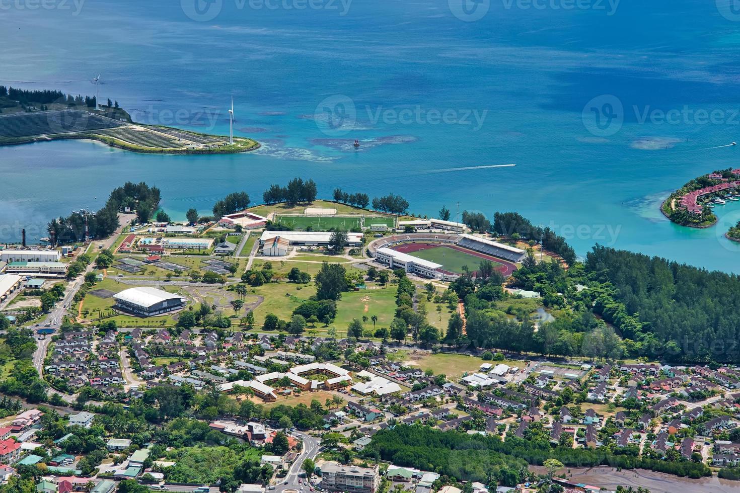 Copolia trail view of the sport complex and residential government home, and the energy island, Mahe Seychelles photo