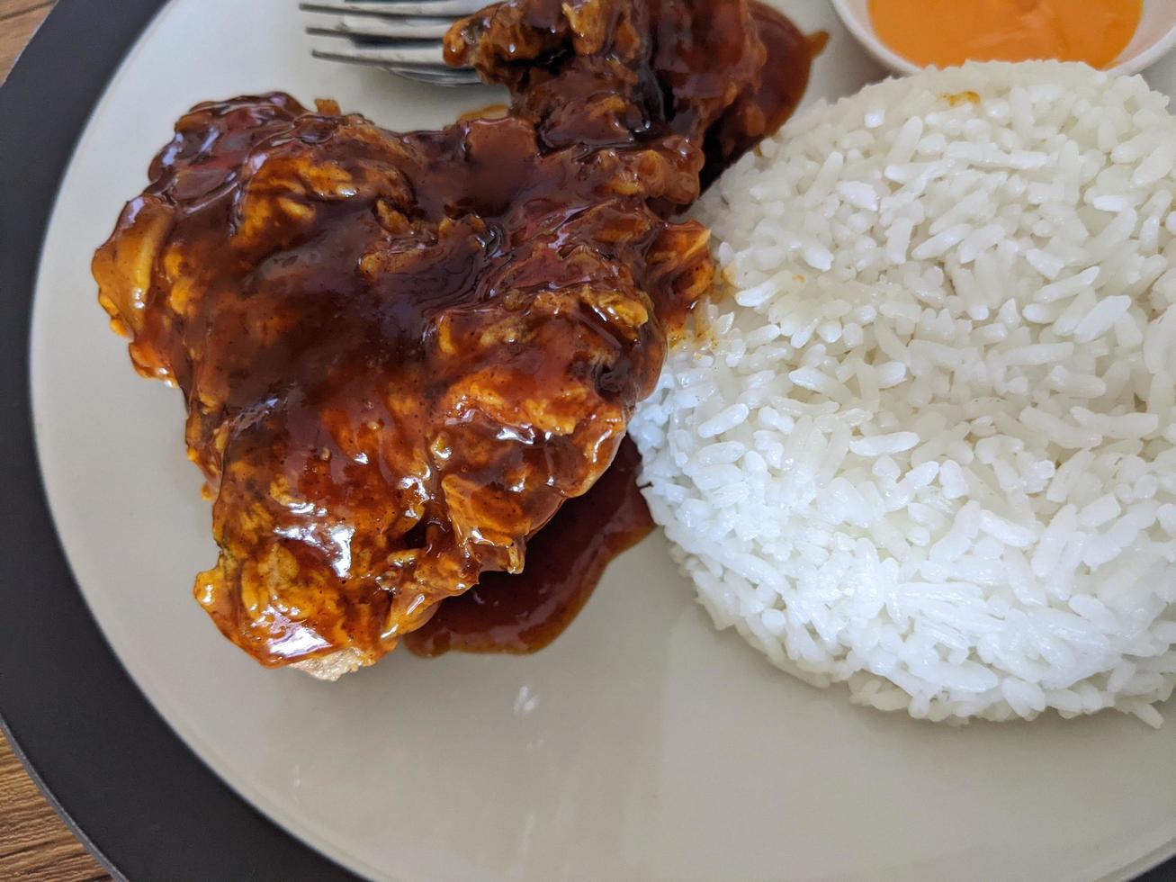 Close up photo of spicy chicken lava with cheese sauce and rice on restaurant. The photo is suitable to use for food background, poster and food content.