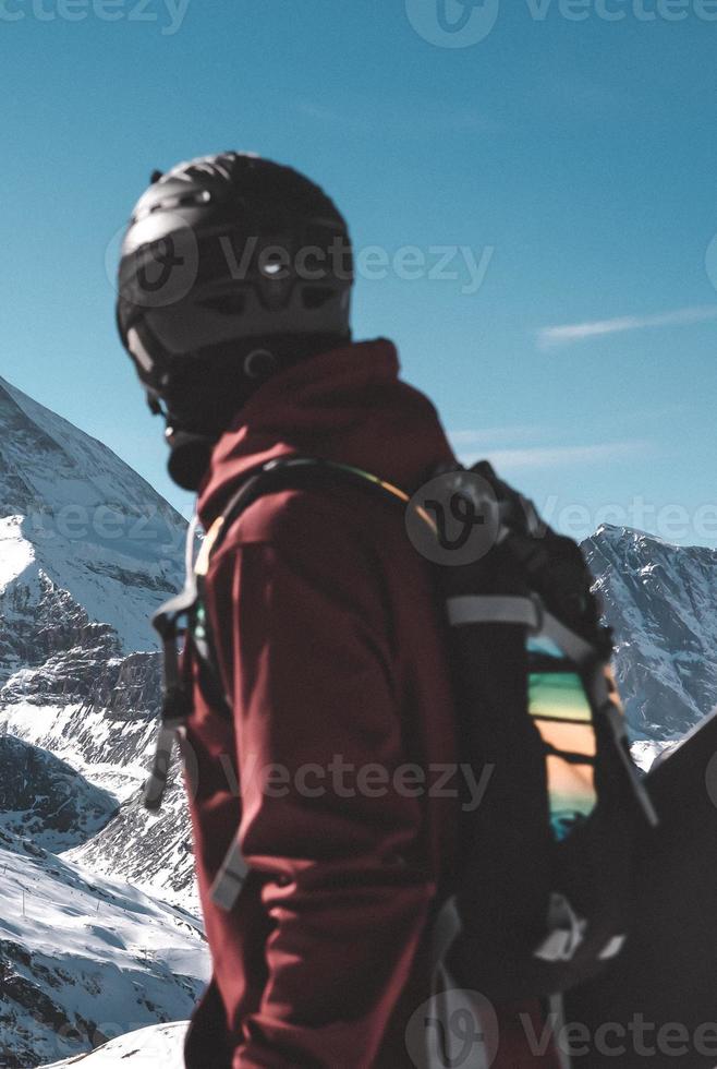 Young snowboarder spending winter holidays in Zermatt, near the famous Matterhorn peak. Male posing in Swiss Alps for the snowboarding season. photo