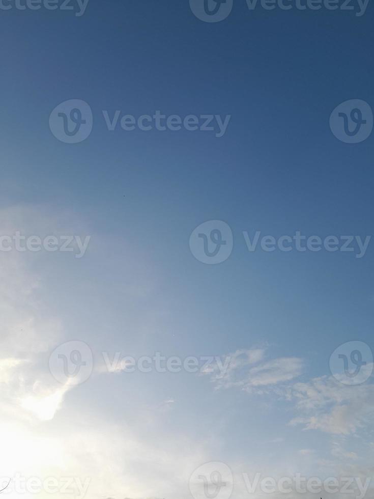 Beautiful white clouds on deep blue sky background. Large bright soft fluffy clouds are cover the entire blue sky. photo