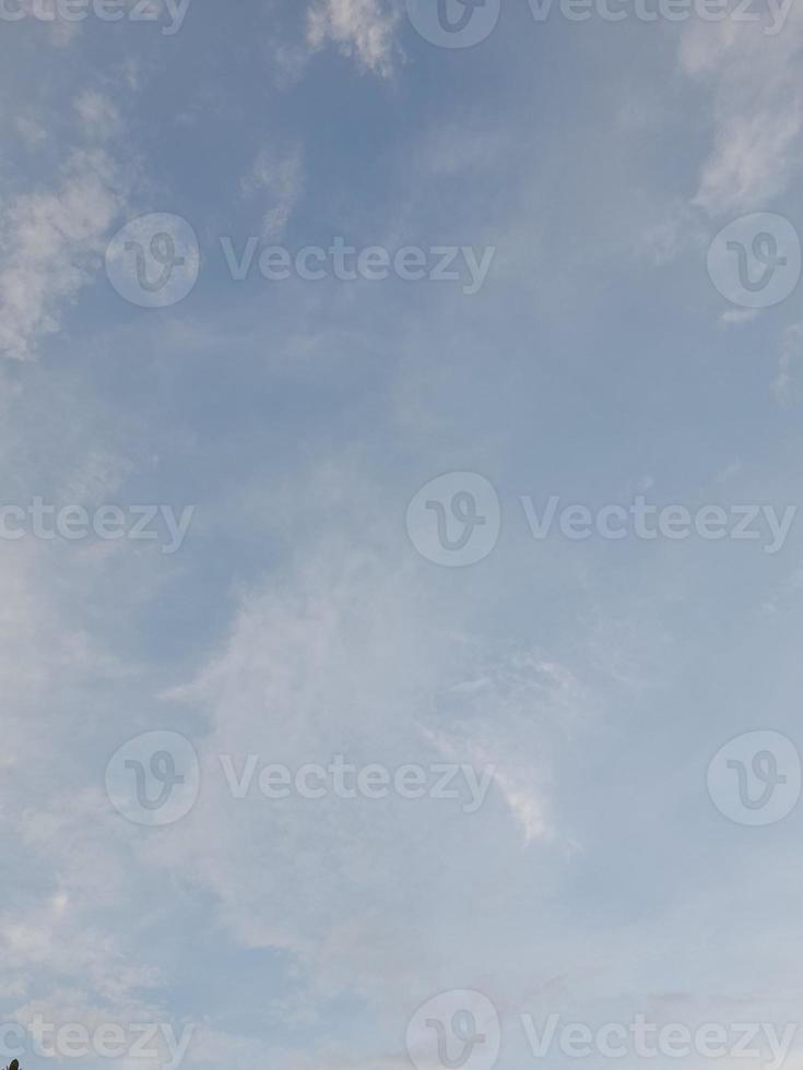 Beautiful clouds on deep blue sky background. Large bright soft fluffy clouds are cover the entire blue sky. photo