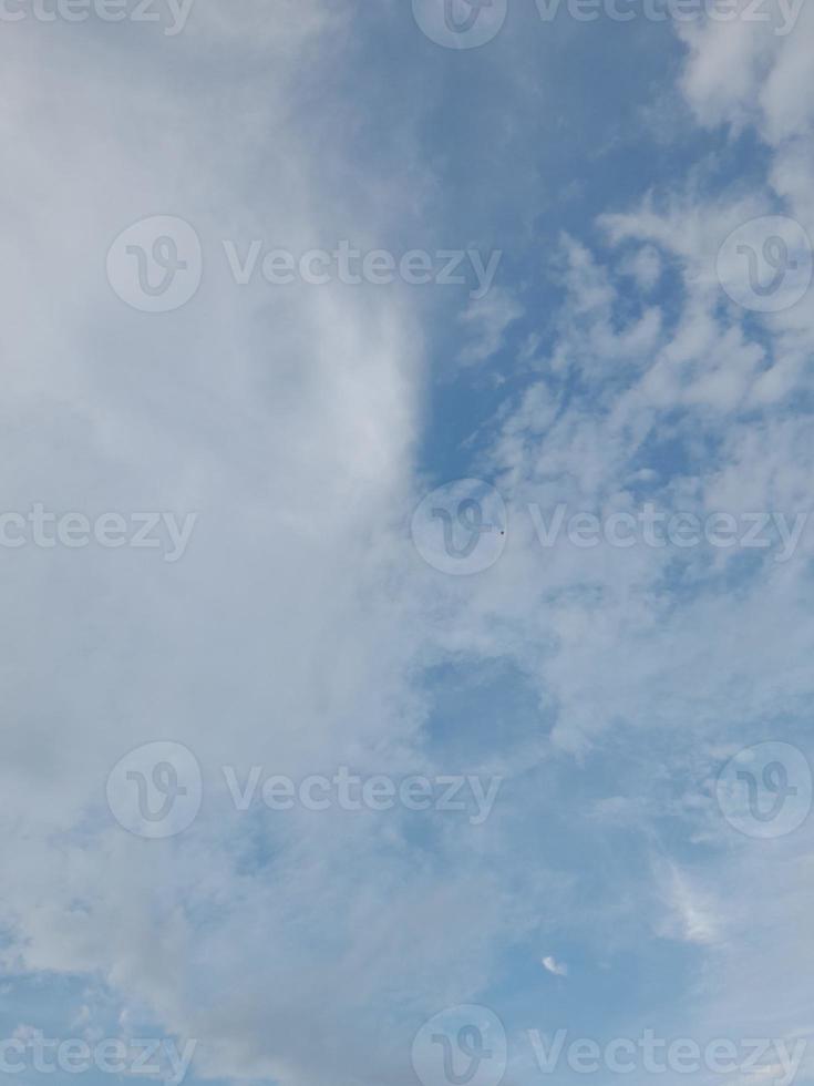 Beautiful clouds on deep blue sky background. Large bright soft fluffy clouds are cover the entire blue sky. photo
