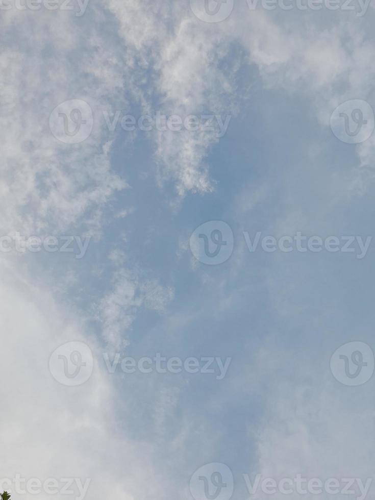 Beautiful clouds on deep blue sky background. Large bright soft fluffy clouds are cover the entire blue sky. photo