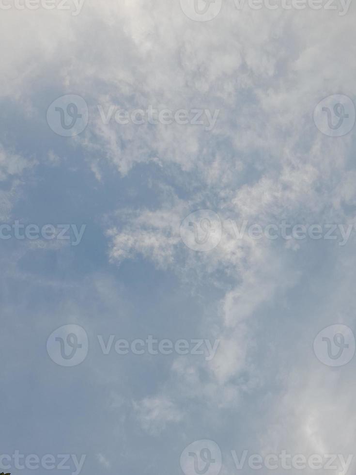 Beautiful clouds on deep blue sky background. Large bright soft fluffy clouds are cover the entire blue sky. photo