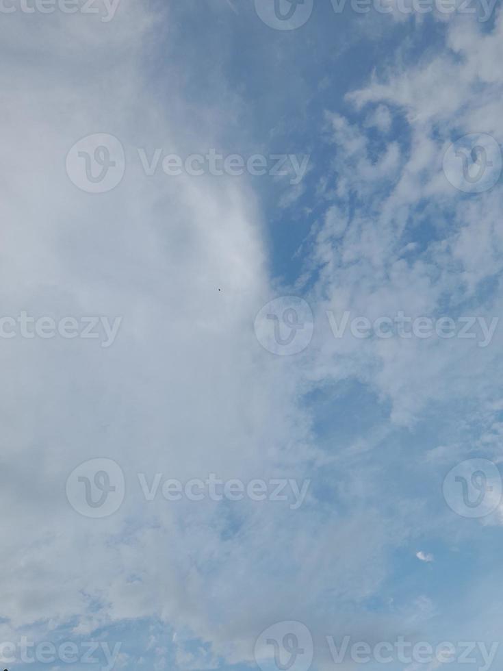 Beautiful clouds on deep blue sky background. Large bright soft fluffy clouds are cover the entire blue sky. photo