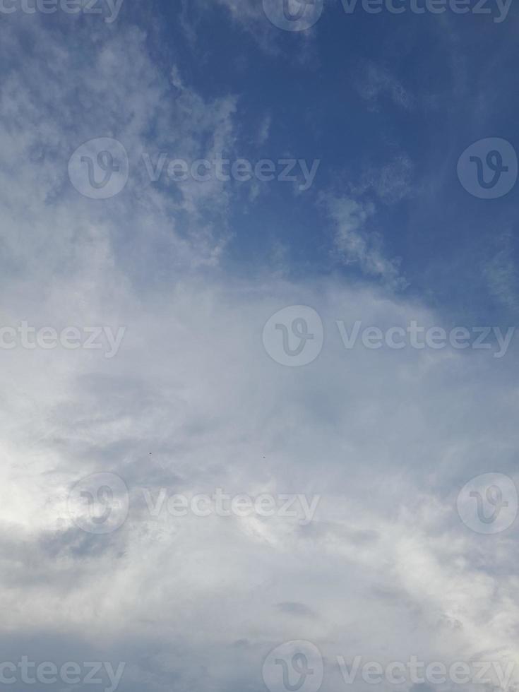 Beautiful clouds on deep blue sky background. Large bright soft fluffy clouds are cover the entire blue sky. photo