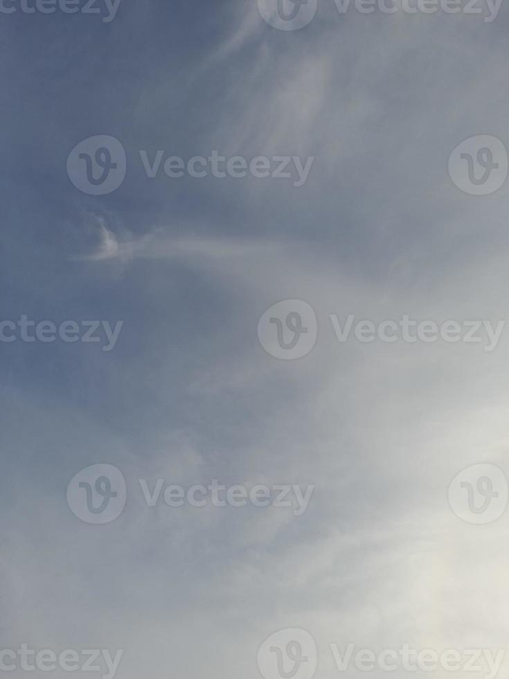 Beautiful white clouds on deep blue sky background. Large bright soft fluffy clouds are cover the entire blue sky. photo