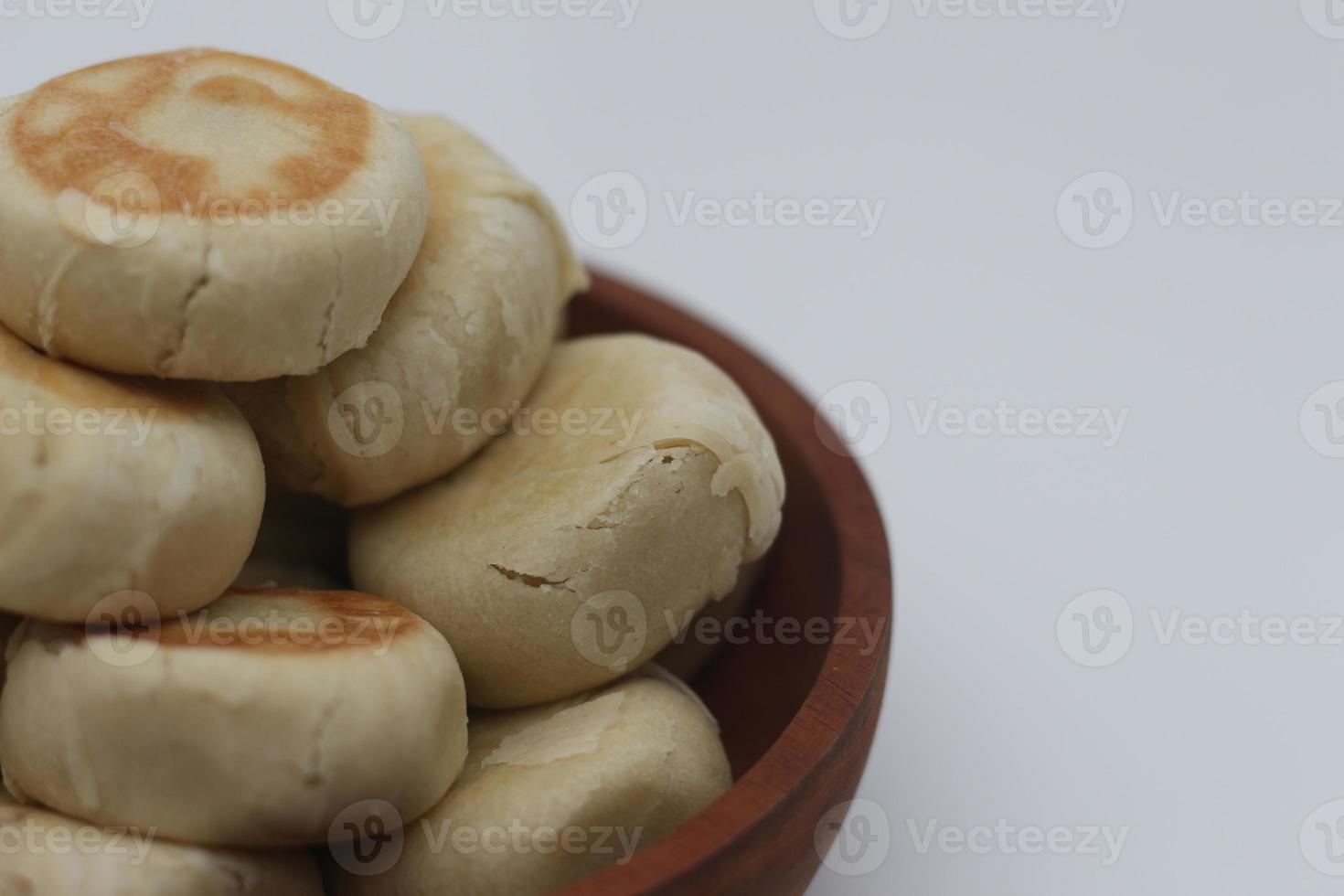 a close up of Bakpia served in a wooden bowl photo