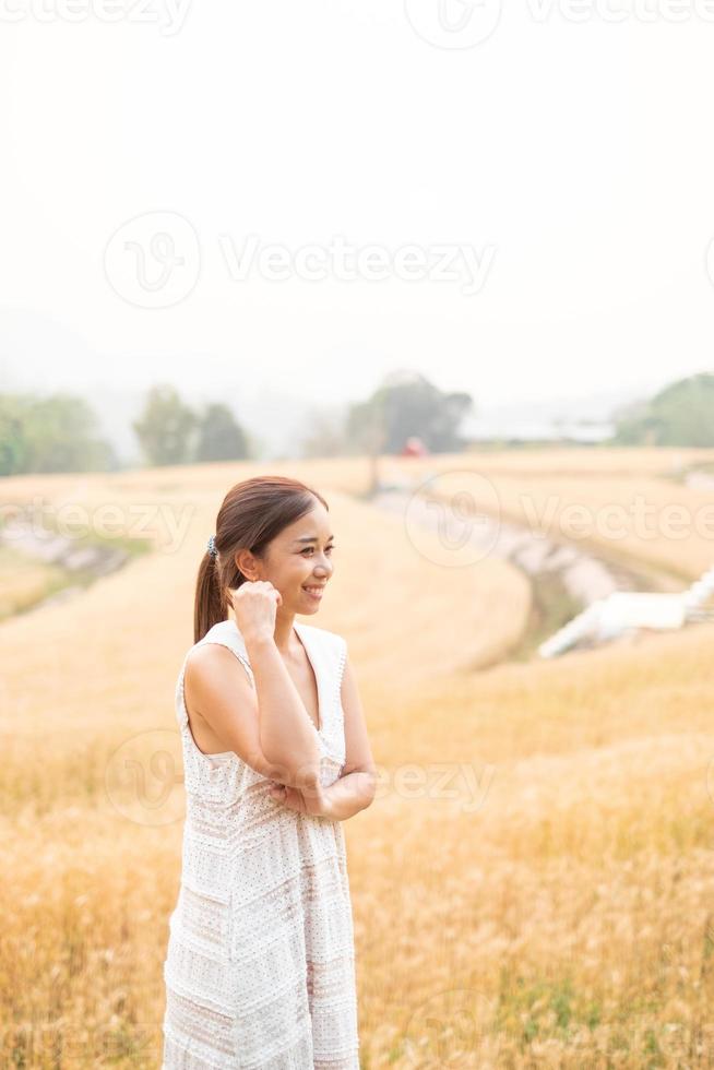 Young Asian women  in white dresses  in the Barley rice field photo