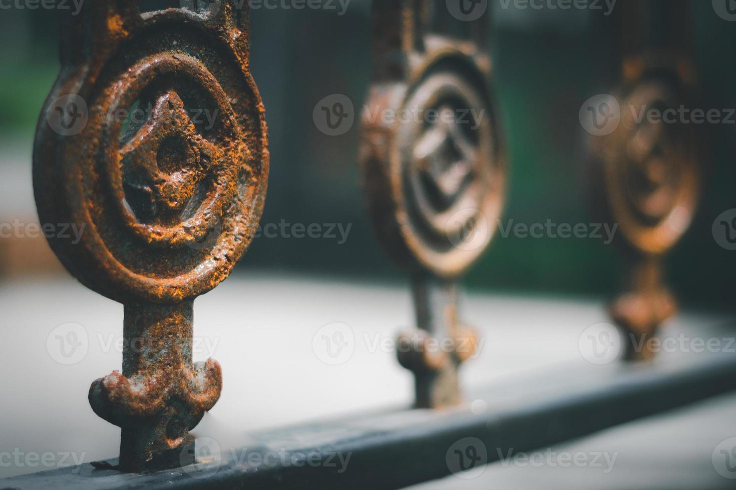 Selective focus of rusty old looking iron fence. photo