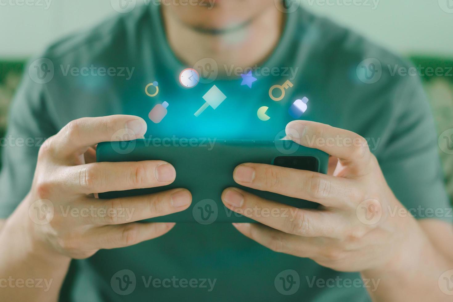 Man playing online game on smartphone. photo