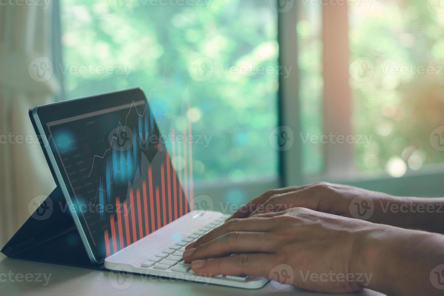 Business man hand typing keyboard to checking stock market on internet. photo