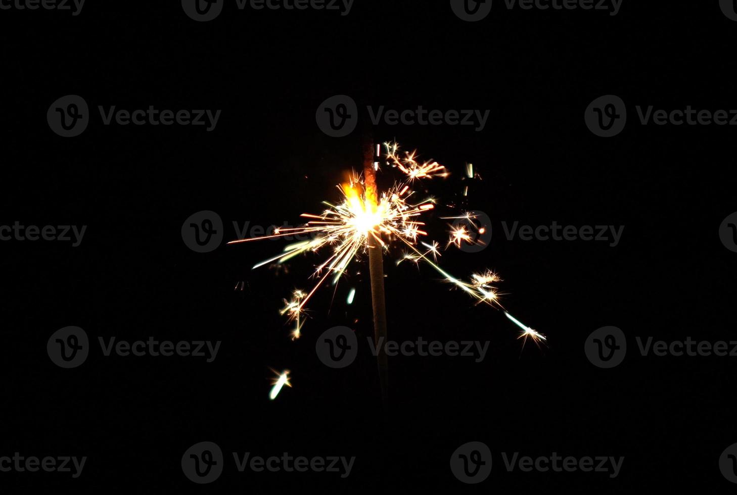 Shiny firework particles spark flare pyrotechnics at night photo