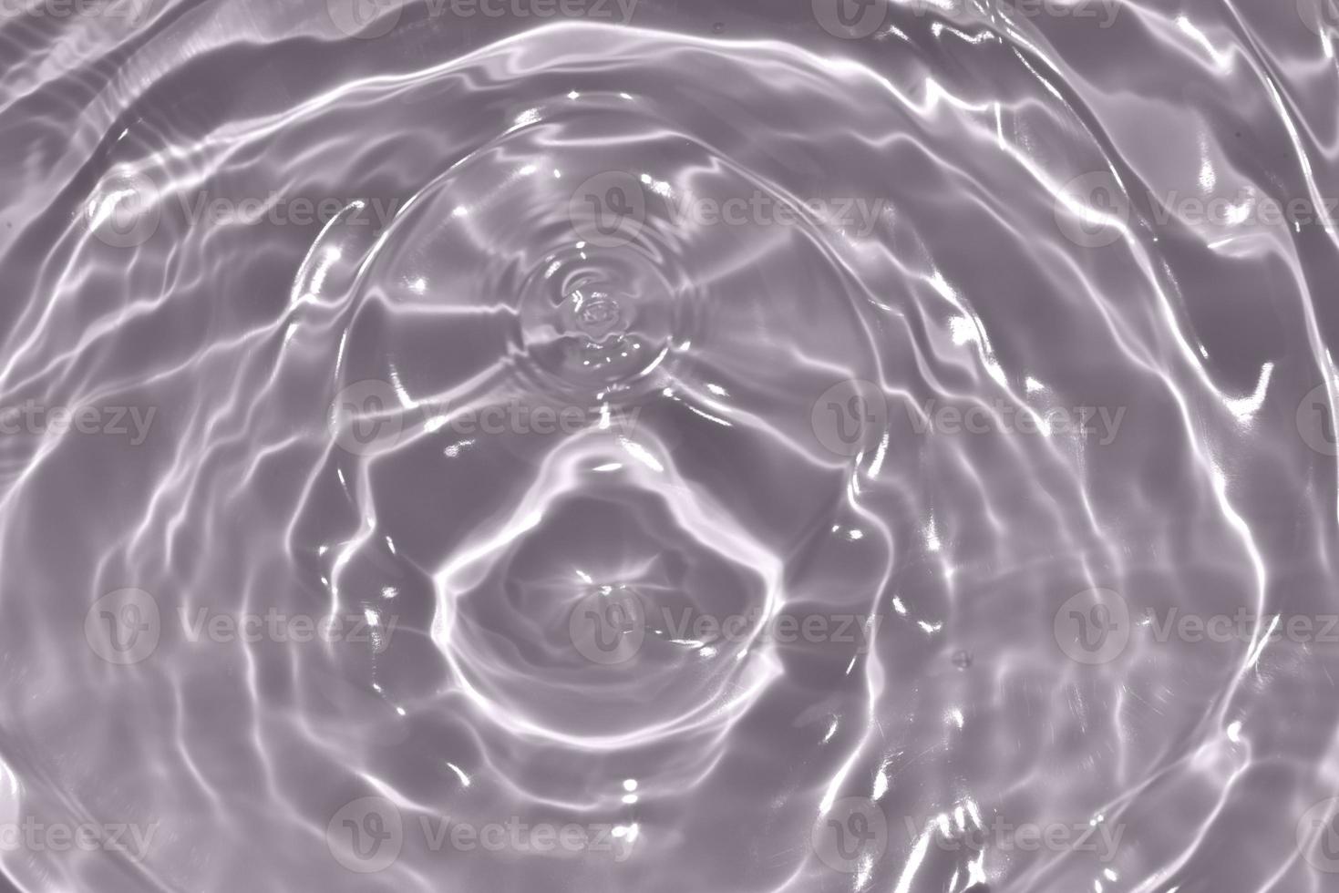 Defocus blurred transparent brown colored clear calm water surface texture with splash, bubble. Shining purple water ripple background. Surface of water in swimming pool. Purple bubble water shine. photo
