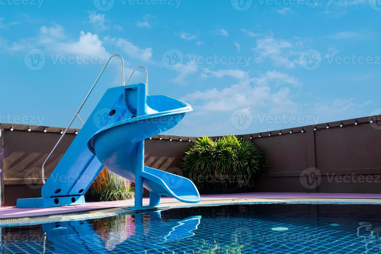 swimming pool with slides over blue sky background. summer concept