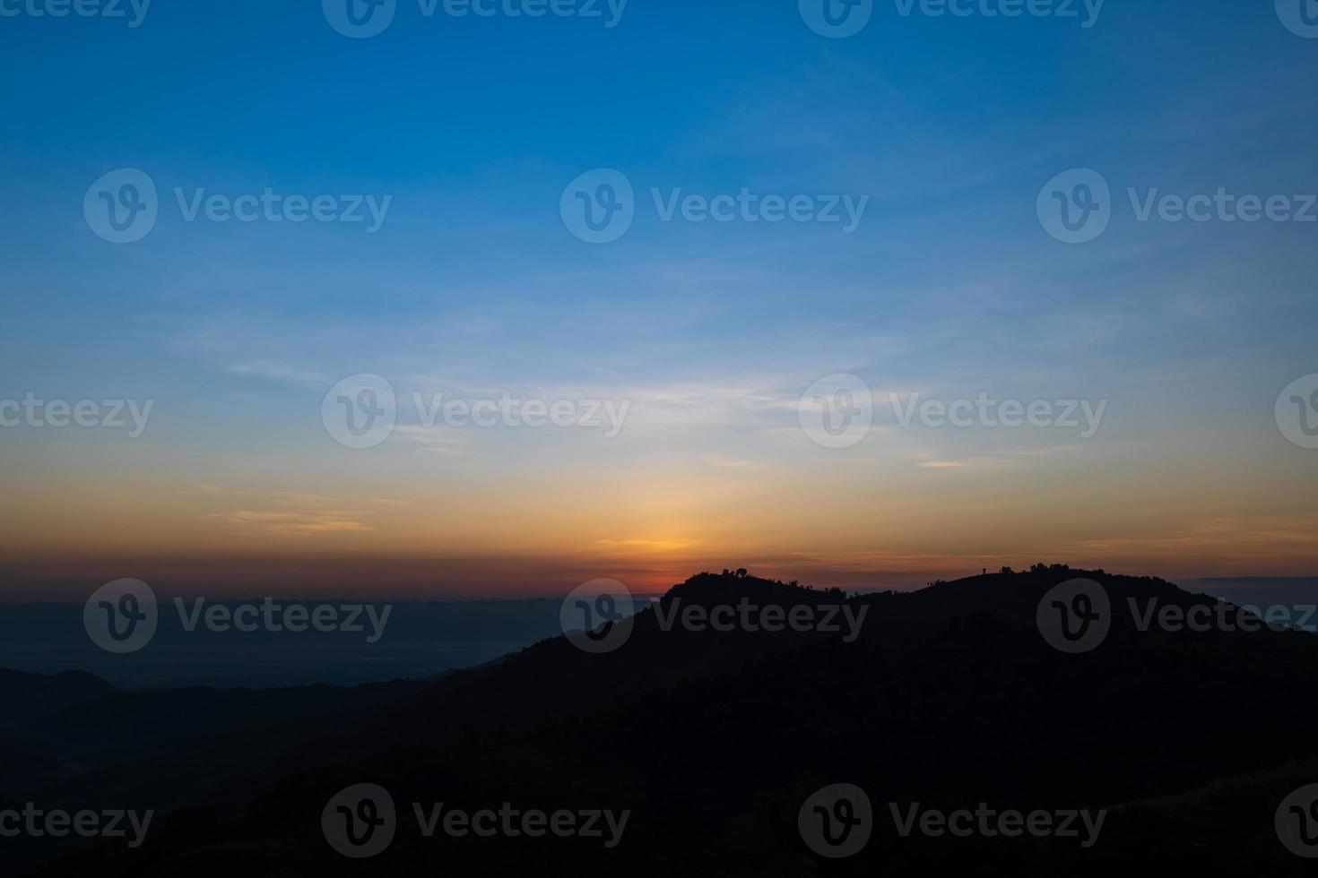 Beautiful sunrise landscape on the mountain of thailand. Golden and blue sky sunrise in the morning. photo