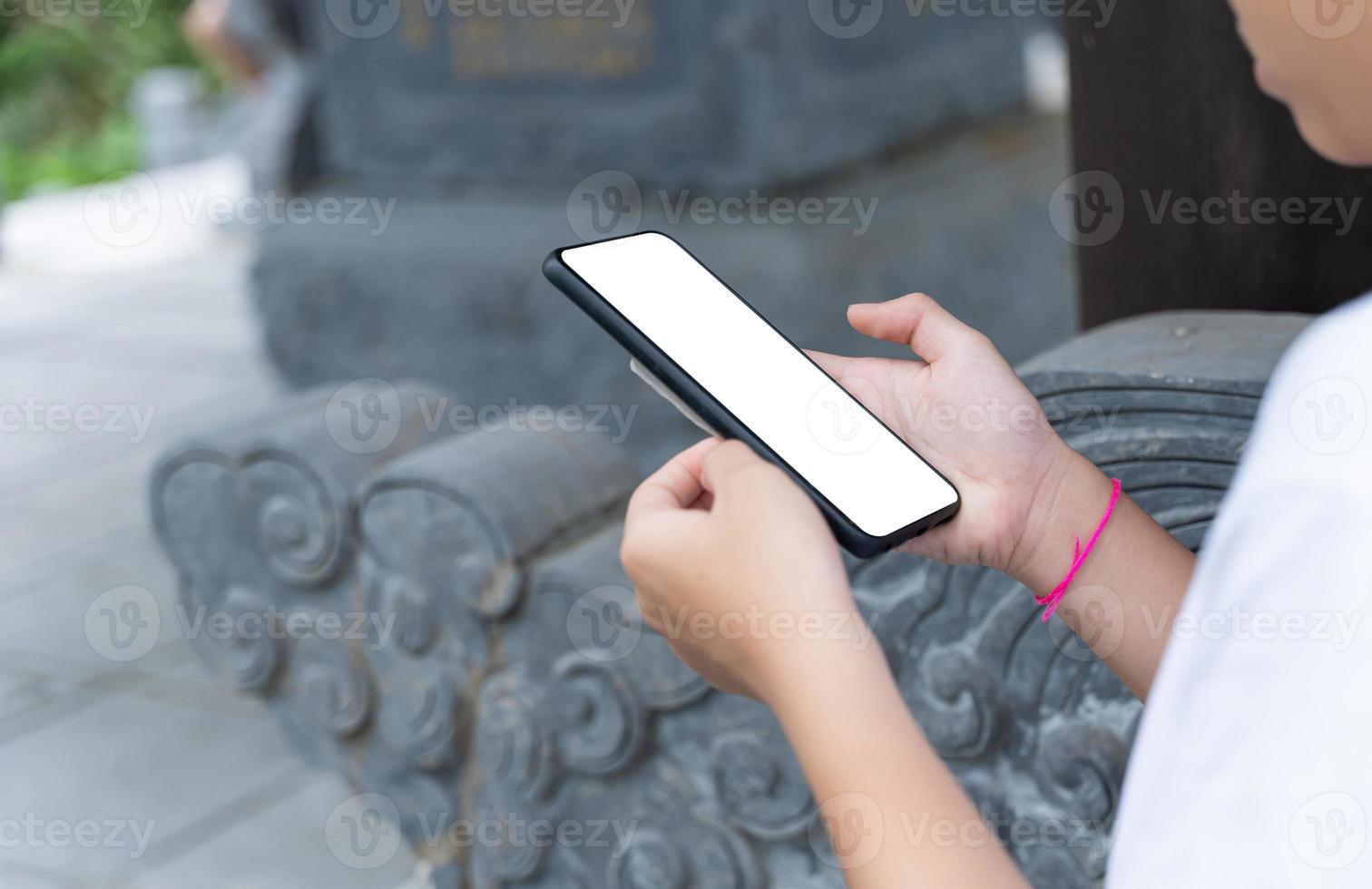 Close up of image hand using mobile phone with blank screen. Searching or social networks concept. photo