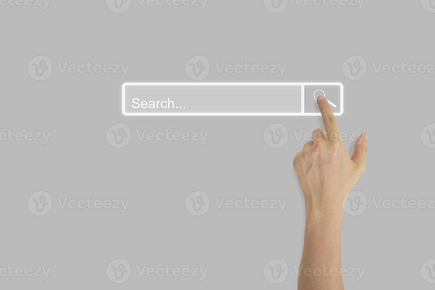 Hand touching magnifying glass icon search page on touch screen with copy space. Concept of searching browsing internet data information networking. photo