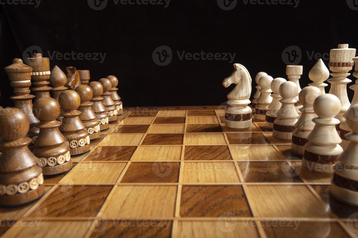 Chess on a dark background. A puzzle game with tricky combinations that requires planning and thinking. photo