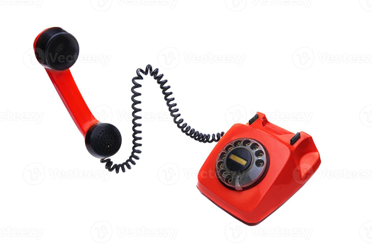 Red vintage telephone with a receiver on a white background. photo