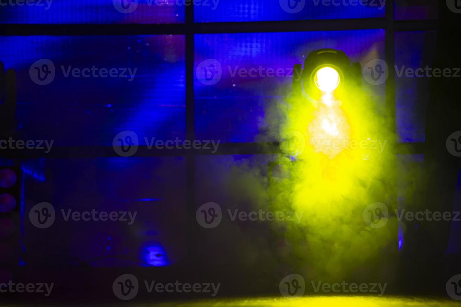 Smoke yellow from a stage smoke machine on a dark background. photo