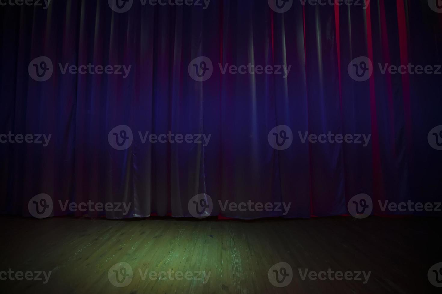 Green dark stage floor and dark purple curtains. photo