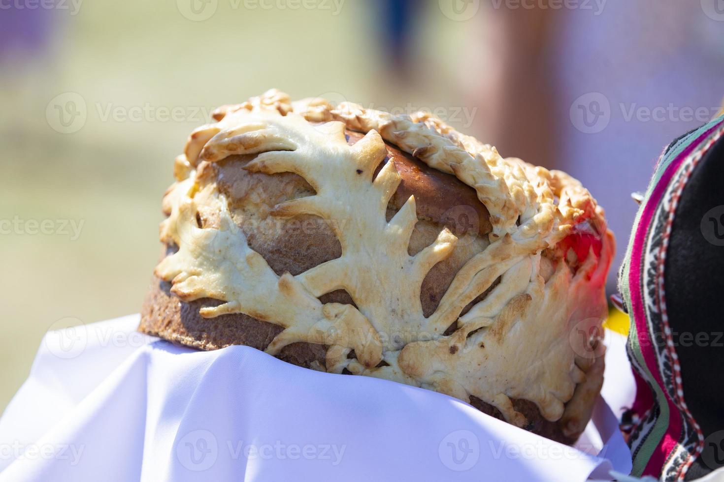 Traditional Slavic loaf in female hands. photo