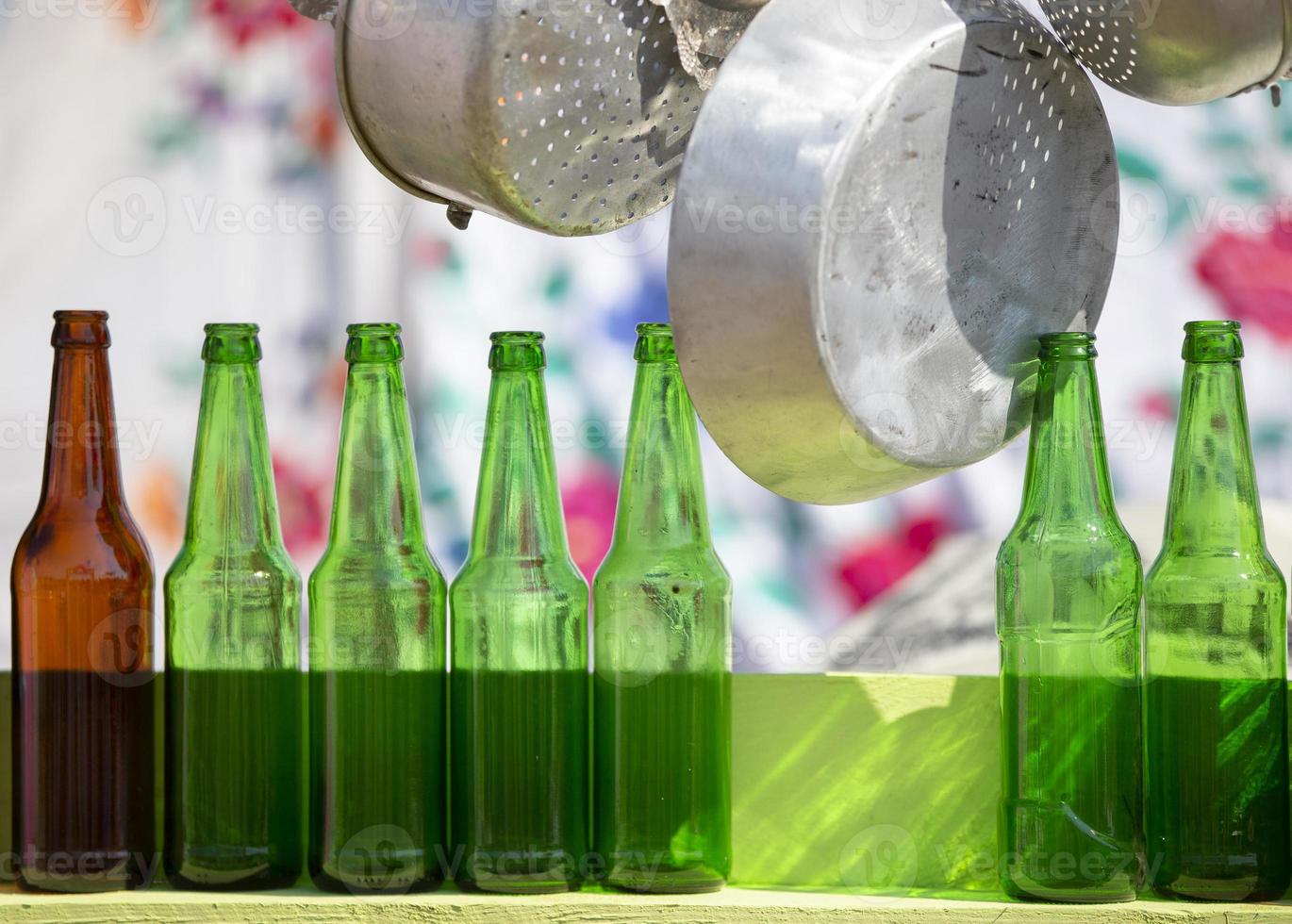 A number of glass bottles and metal dishes. photo