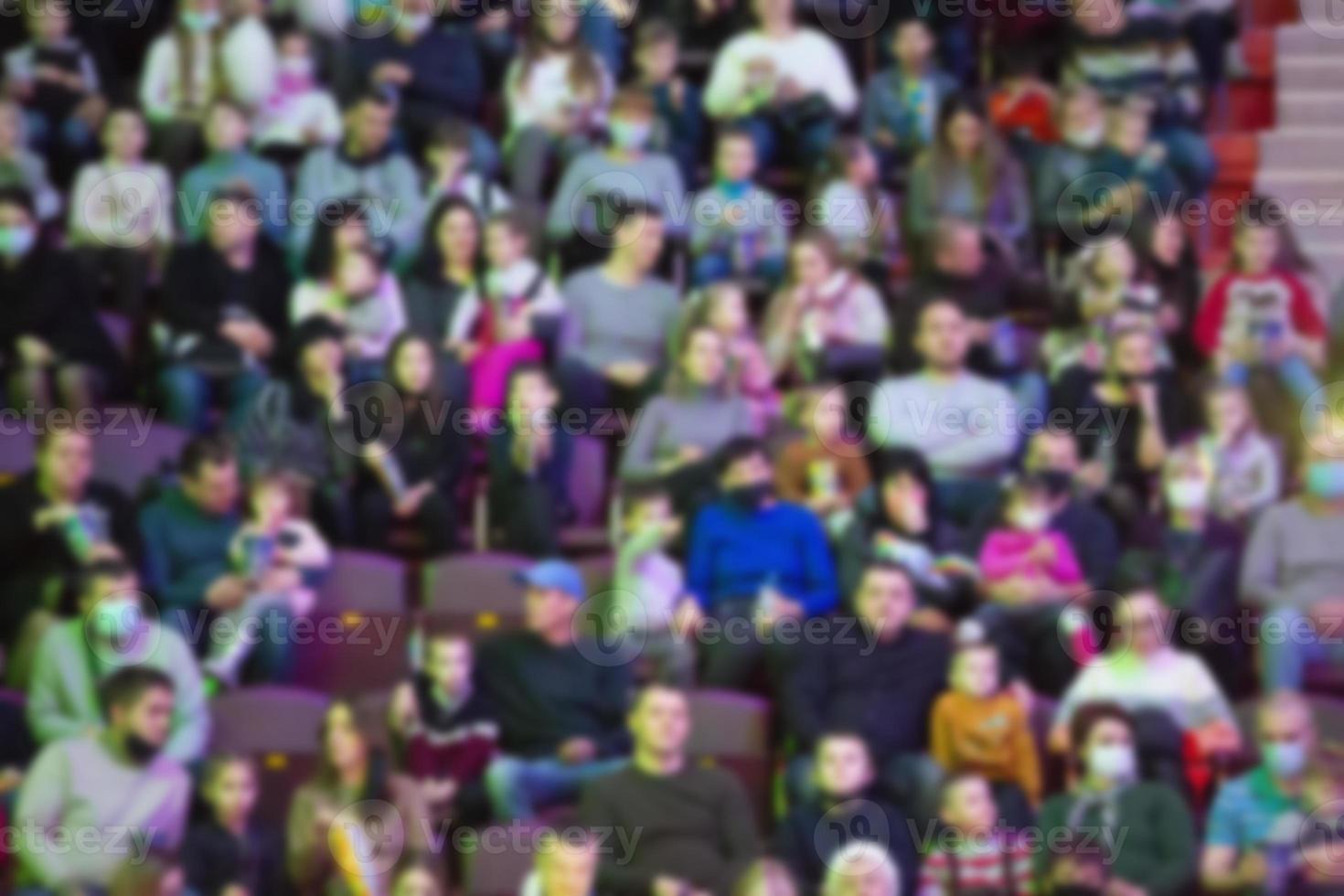 A blurred crowd of spectators in a stadium at a sporting event photo