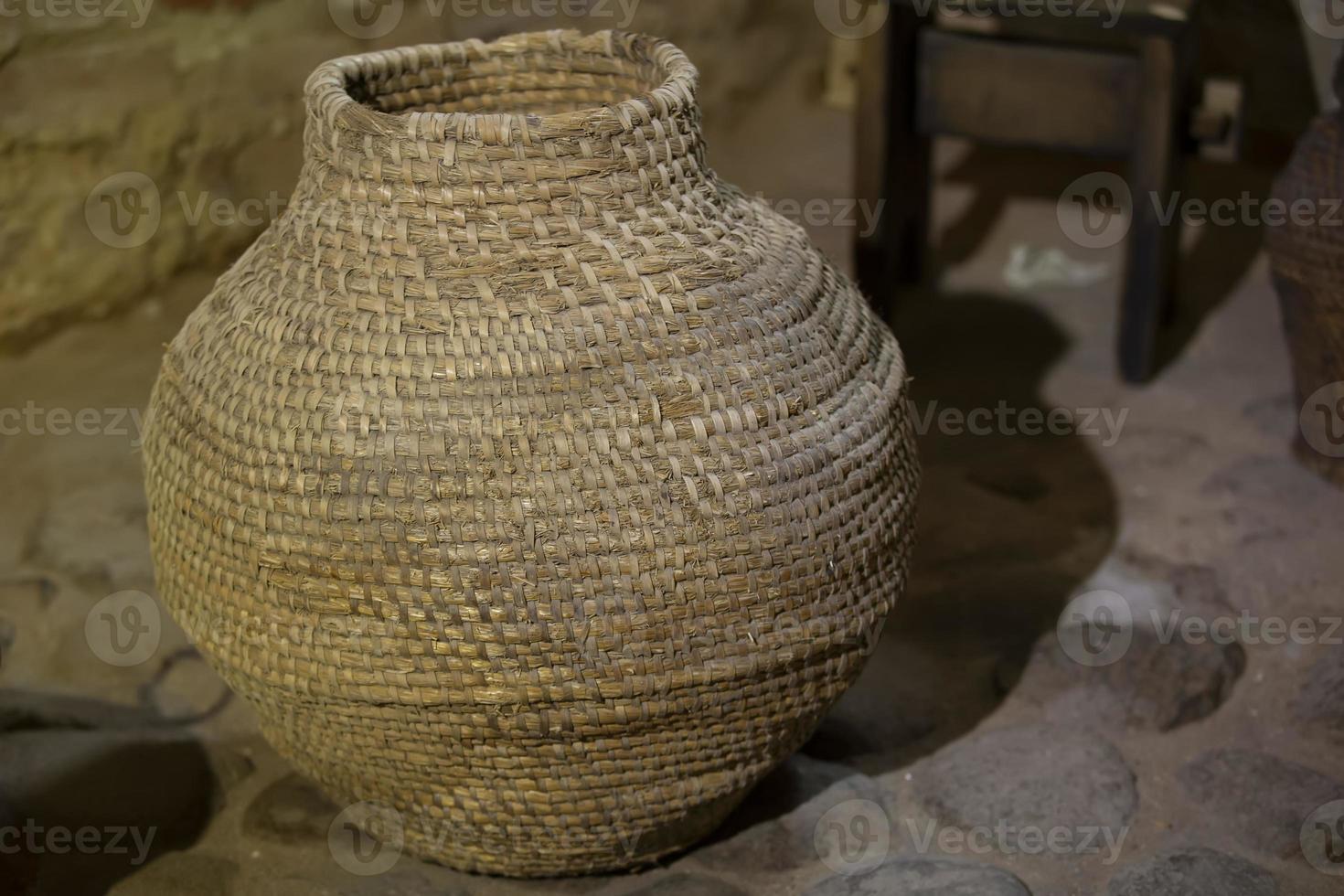 Old wicker vine container jug for wine. photo