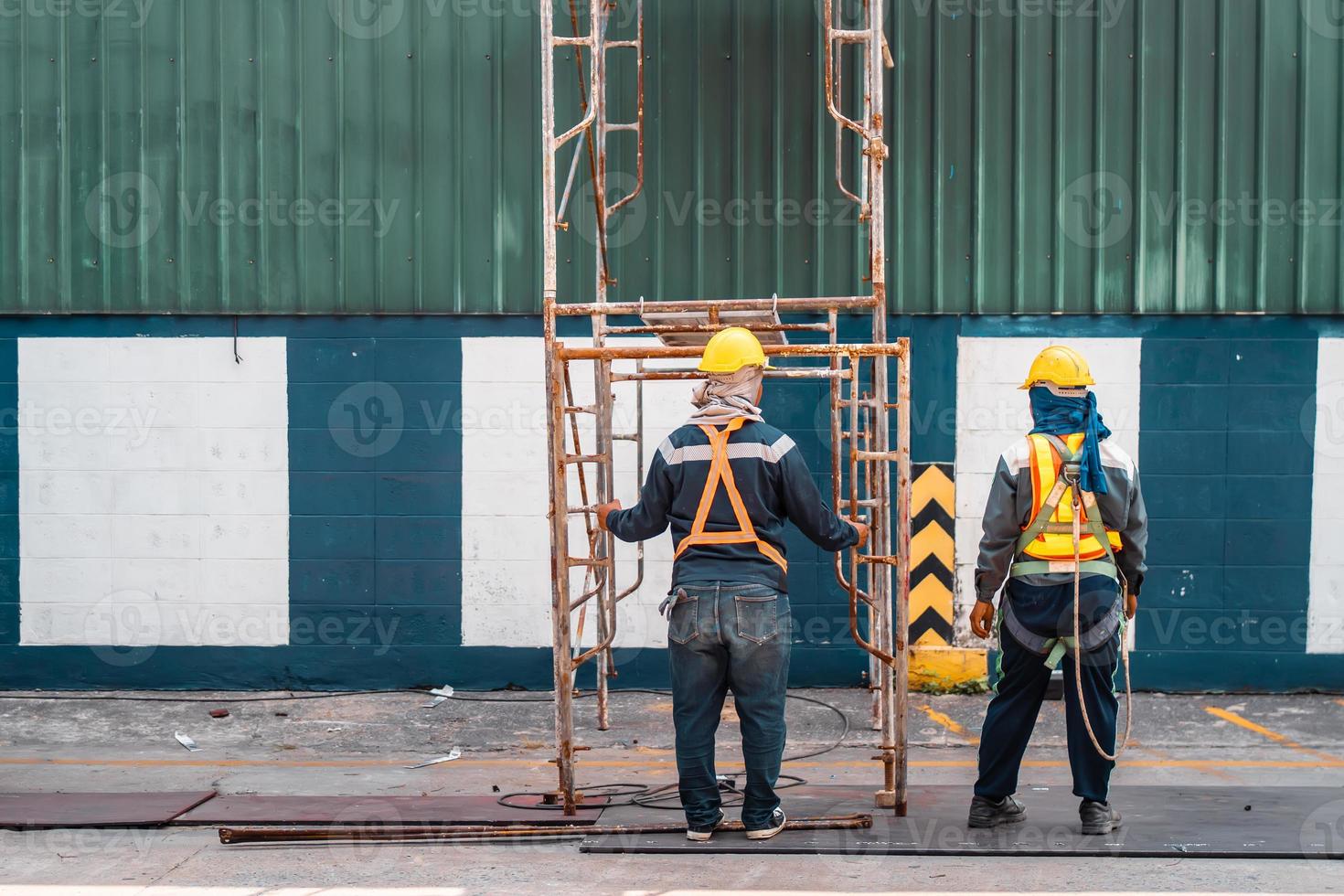 Construction worker wearing safety harnesses with Scaffolding at construction site. working at heights above ground ,Safe working for Scaffolding concept photo