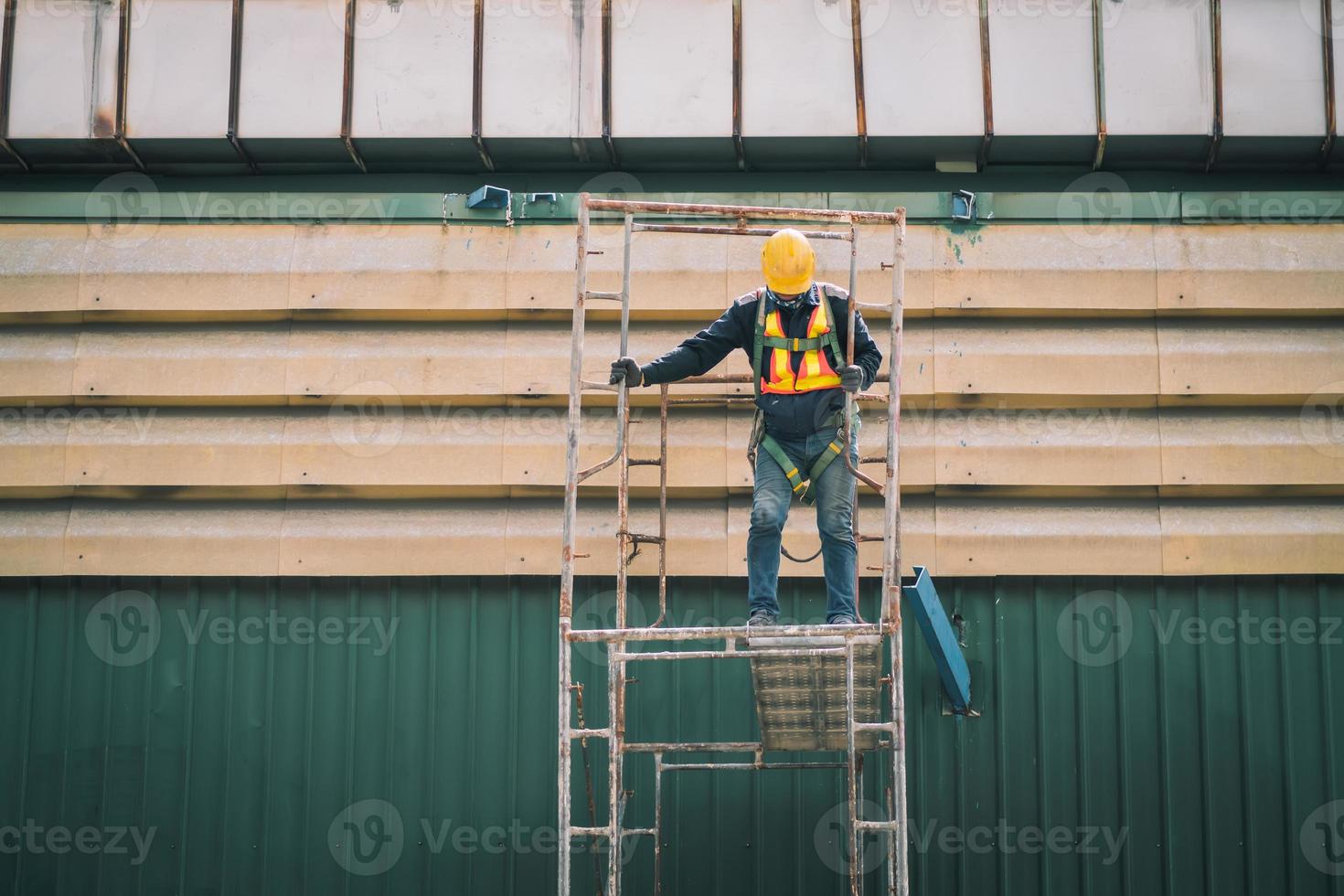 Construction worker wearing safety harnesses on Scaffolding at construction site. working at heights above ground ,Safe working for Scaffolding concept photo